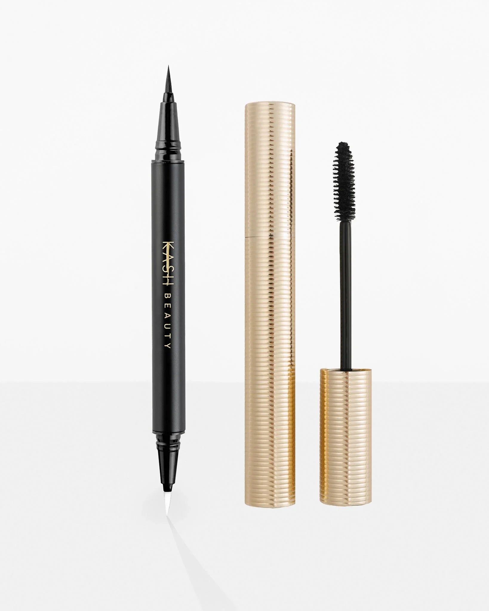 Eyeliner and mascara with gold and black design on a white background