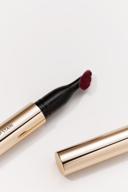 Lip stain pen with applicator on a white background
