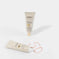 Radiant Canvas primer with SPF 50 in beige tubes, one standing, one open with product swatch