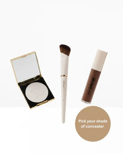 Pressed powder compact, makeup brush, and liquid concealer tube on white background, beauty products