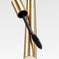 Gold mascara tube with textured finish and black mascara wand on white background