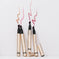 Four gold lip stain pens with various pink and nude swatches on a white background.
