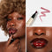 Model wearing deep berry lip gloss, makeup swatch and applicator, close-up beauty shot