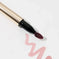 Lip stain applicator with mauve pink swatch on white background, makeup cosmetics
